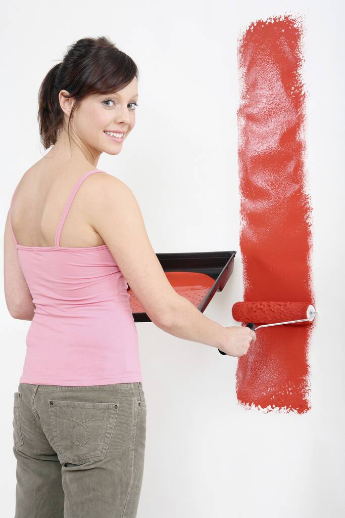 Woman painting wall with paint roller - Photo, Image