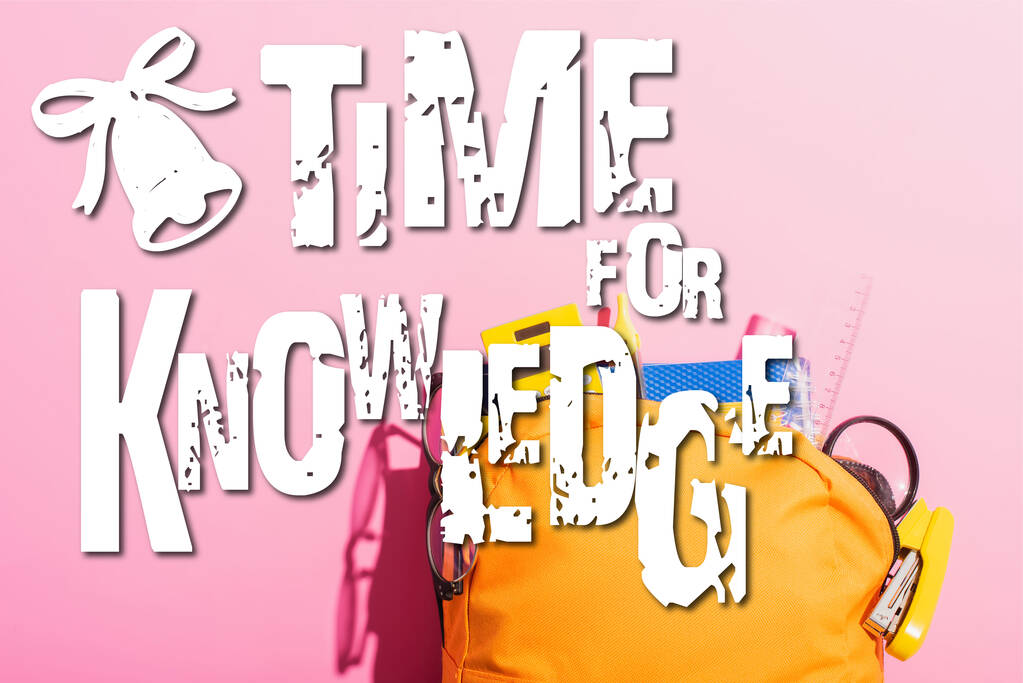 yellow backpack packed with school stationery and eyeglasses near time for knowledge lettering on pink - Photo, Image