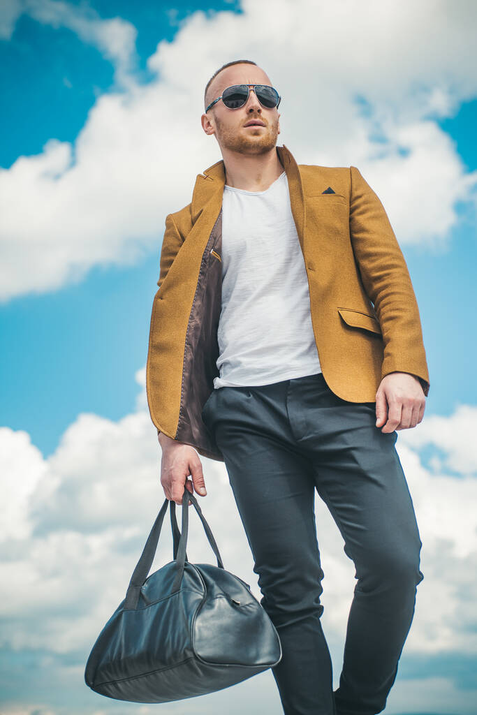 Portrait of young stylish man with bag in the street, life style. - Photo, Image