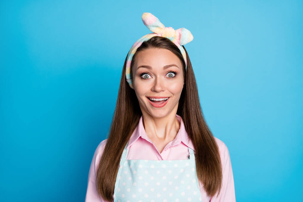 Closeup photo of attractive shocked lady listen nice news open mouth overjoyed facial expression wear headband dotted apron pink shirt isolated blue color background - Photo, Image