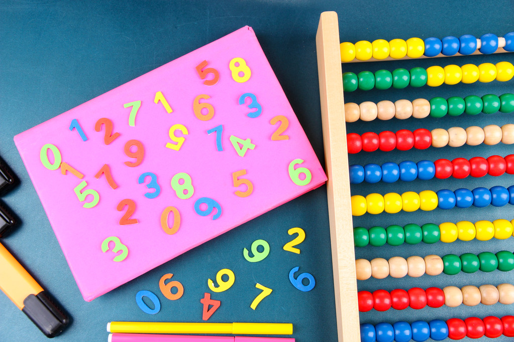 Colorful numbers, abacus, books and markers on school desk background - Photo, Image