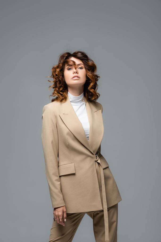 elegant woman in beige suit posing isolated on grey - Photo, Image