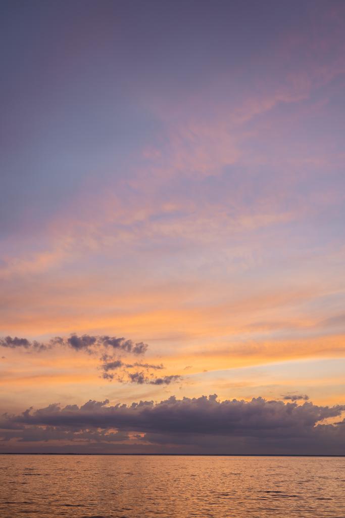 Meereslandschaft und wolkenverhangener Himmel bei Sonnenuntergang  - Foto, Bild