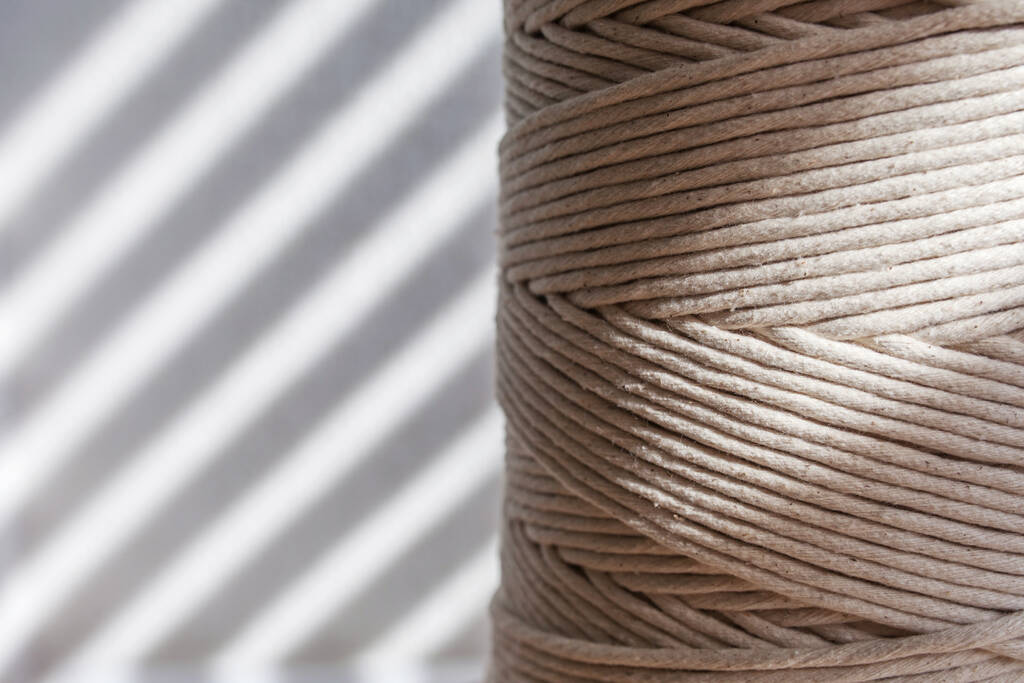 Handmade macrame braiding and cotton threads close up. Hobby knitting cotton yarn reel. Female hobby. Copy space - Photo, Image