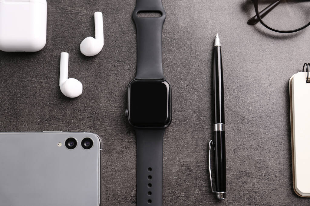 Flat lay composition with stylish smart watch on grey stone table - Photo, Image