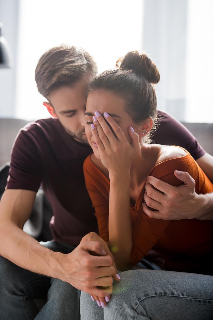 tender man calming depressed woman covering face with hand  - Photo, Image