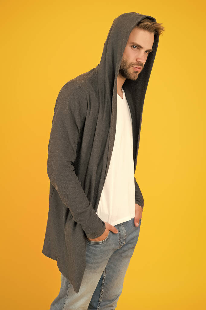 Casual but stylish. Stylish man yellow background. Handsome guy wear stylish hoodie. Fashion trends for young men. Modern clothing style. Create stylish urban look - Photo, Image