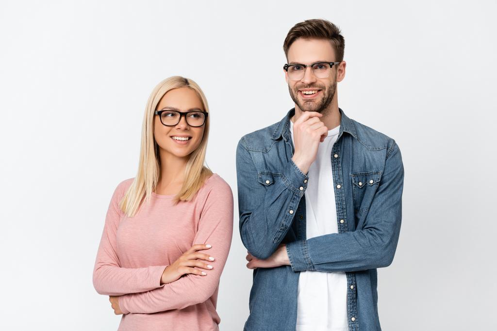 Young woman in eyeglasses standing near smiling boyfriend isolated on grey - Photo, Image