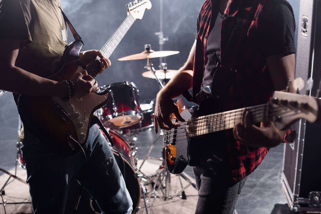 KYIV, UCRAINA - 25 AGOSTO 2020: Vista ritagliata di musicisti rock band con chitarre elettriche su sfondo sfocato - Foto, immagini