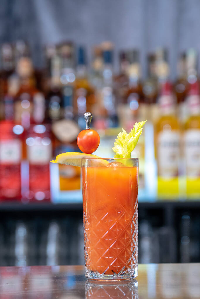 A closeup shot of a refreshing cocktail in the bar on blurred background - Photo, Image