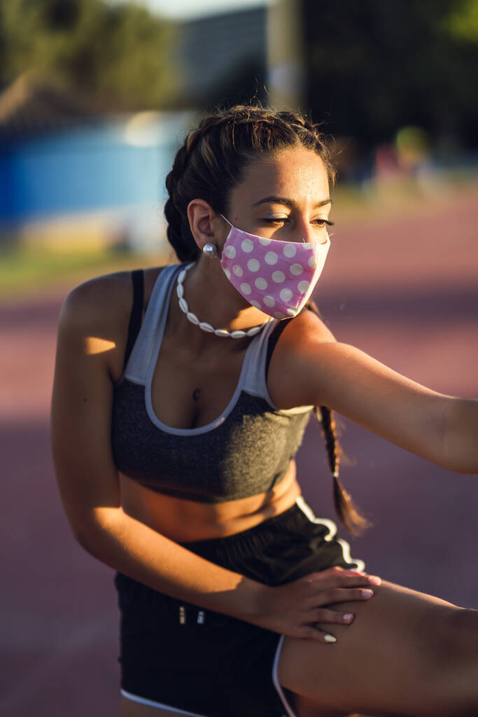 Svislý záběr ženy v masce natažené před cvičením - Fotografie, Obrázek