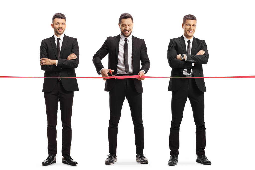 Full length portrait of a three businessmen cutting a red ribbon tape at an event opening isolated on white background - Photo, Image