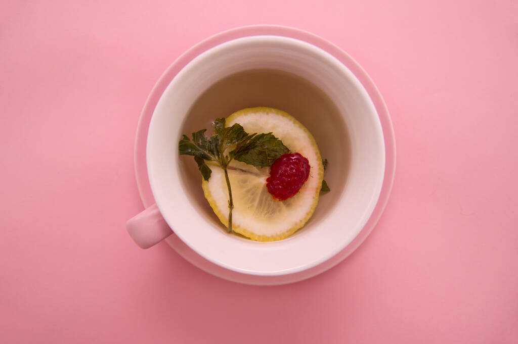 Cup Raspberry Mint Lemon Tea Pink Background Tropical Summer Flat Lay Food concept. Disease prevention. - Photo, Image