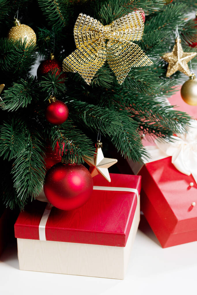 Close up of decorates Christmas tree and gifts on white - Photo, Image