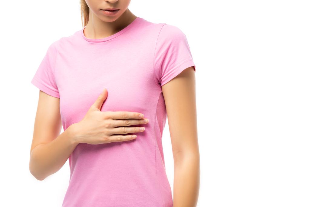 Cropped view of young woman in pink t-shirt touching breast isolated on white, concept of breast cancer - Photo, Image