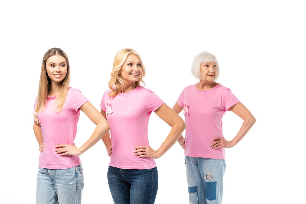 Ženy s rukama v bok a stuhami vědomí rakoviny prsu izolované na bílém - Fotografie, Obrázek