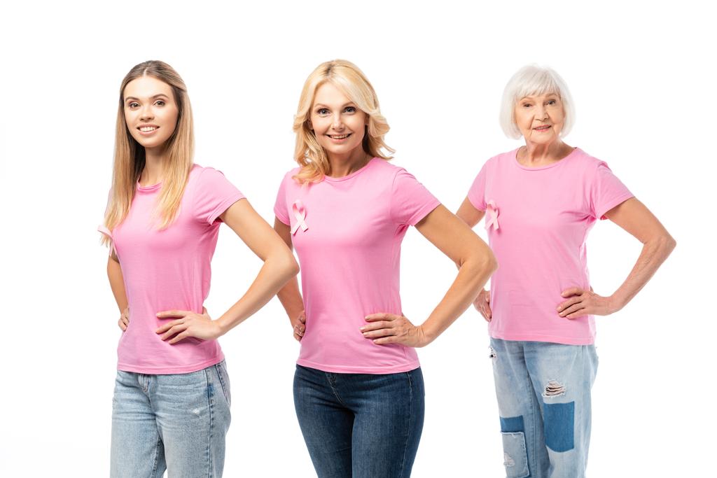 Donne con le mani sui fianchi guardando la fotocamera isolata sul bianco, concetto di consapevolezza del cancro al seno  - Foto, immagini