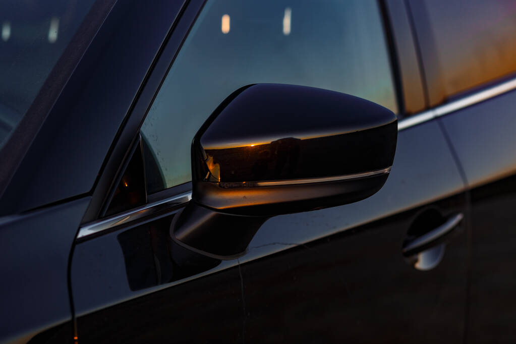Part of the body of a black car at sunset - Photo, Image
