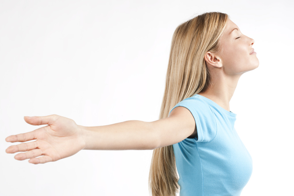 Relaxed young woman with arms outstretched - Photo, Image