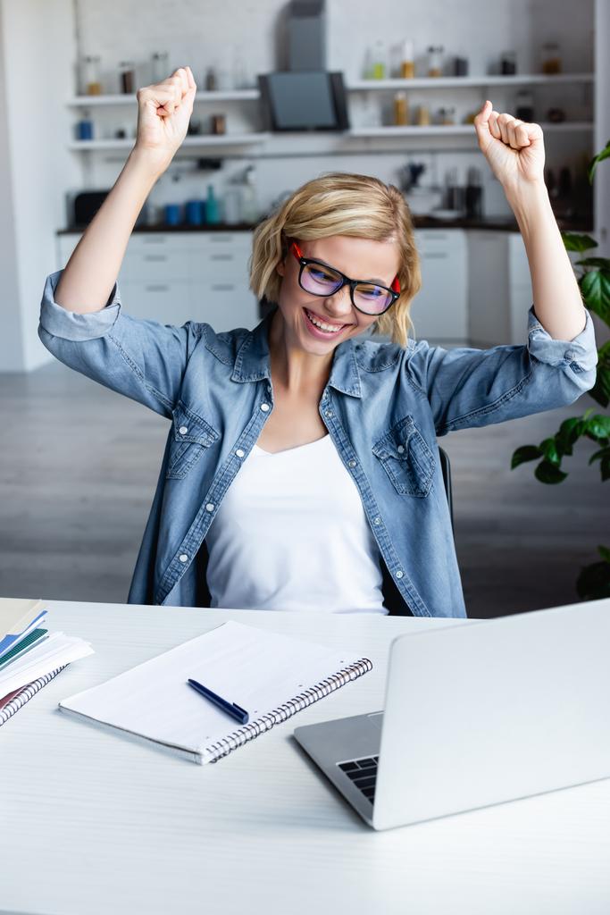 young blonde woman in eyeglasses happy with raised hands - Photo, Image