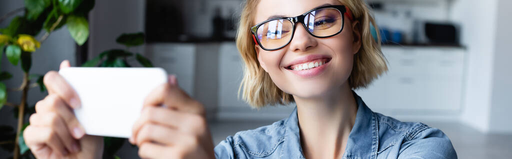 young blonde woman taking selfie while working from home, horizontal banner - Valokuva, kuva