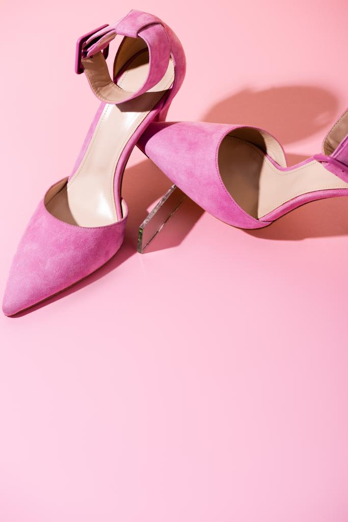 pair of elegant suede heeled shoes on pink background - Photo, Image