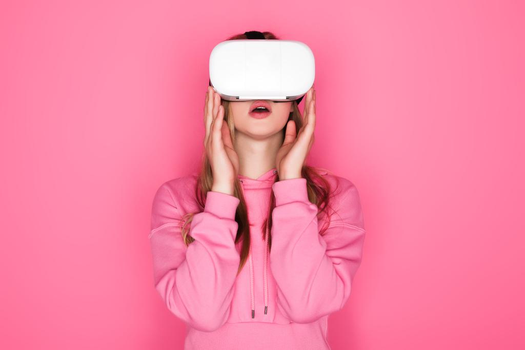 shocked beautiful woman in vr headset on pink background - Photo, Image
