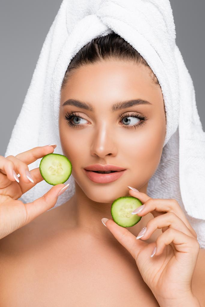 woman with towel on head and cucumber isolated on grey - Photo, Image