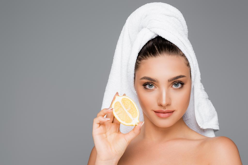 woman with towel on head and lemon for radiant skin - Photo, Image