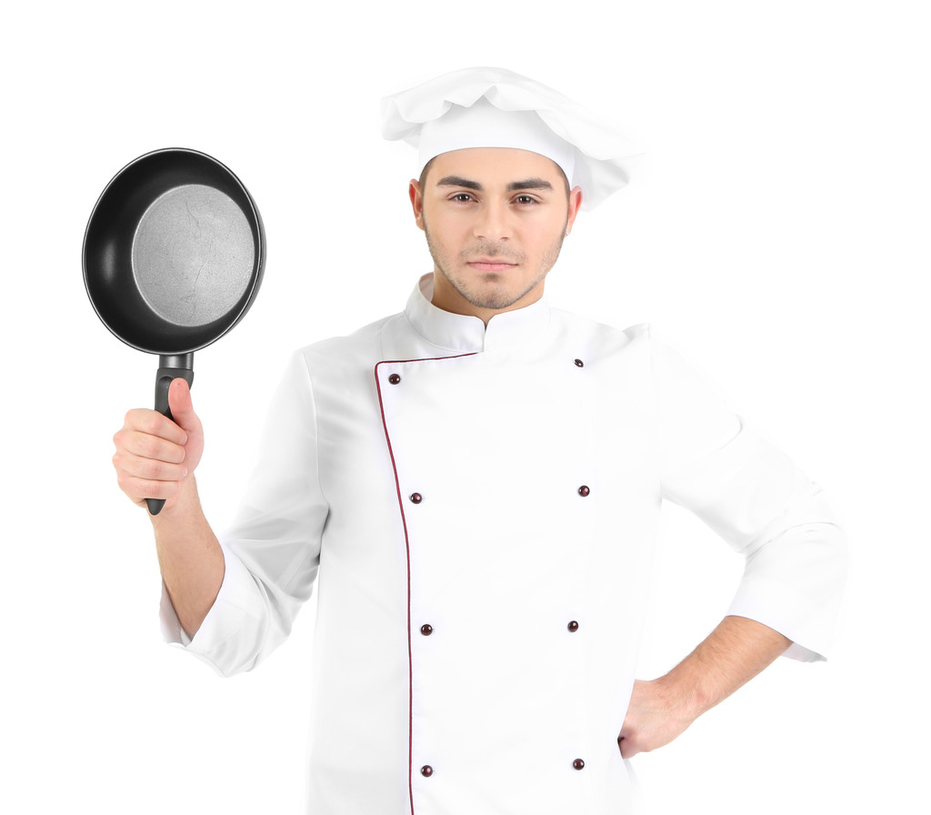 profesionální kuchař v bílém jednotné a klobouk, drží pan v jeho rukou, izolované na bílém - Fotografie, Obrázek