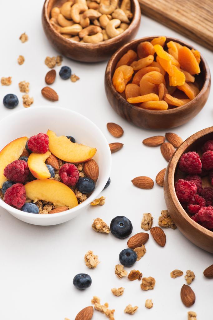leckeres Müsli mit Nüssen und Früchten auf weißem Hintergrund - Foto, Bild