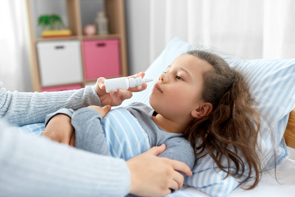 mother with nasal spray treats sick daughter - Photo, Image