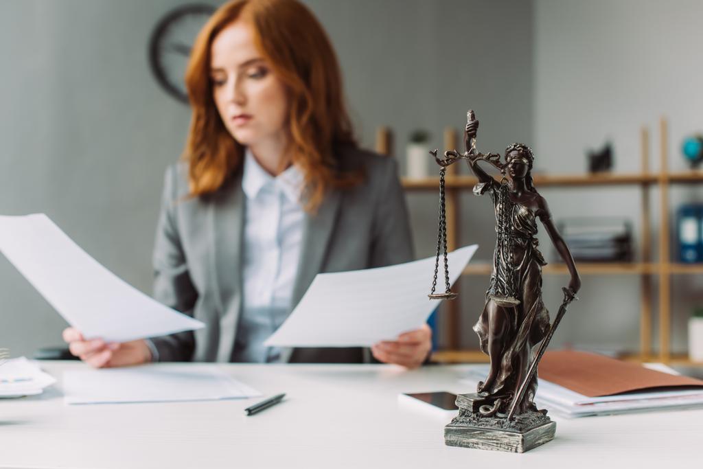 Themis figurine na mesa com advogado desfocado com folhas de papel em segundo plano - Foto, Imagem