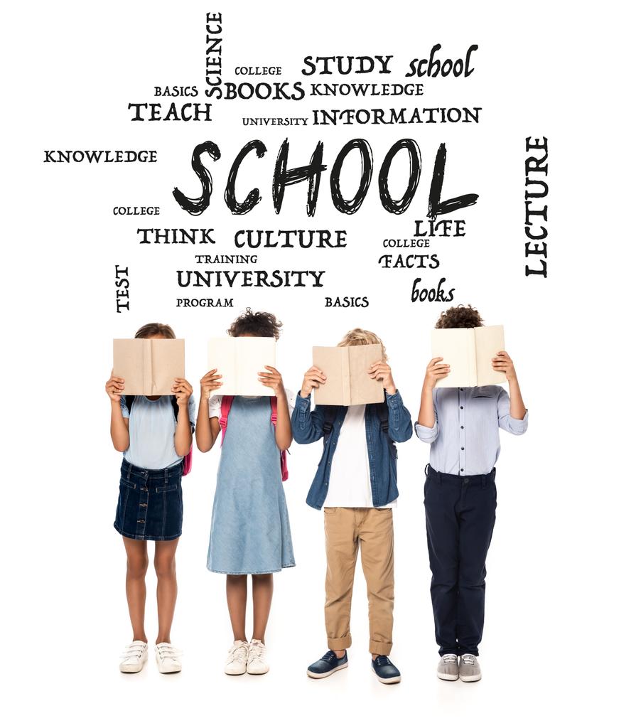 multicultural schoolgirls and schoolboys covering faces with books near lettering on white  - Photo, Image