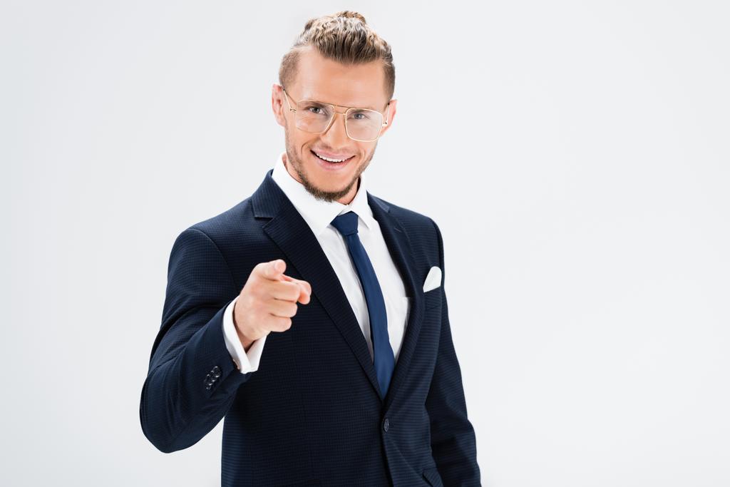 happy young businessman in suit and glasses pointing at camera isolated on white - Photo, Image