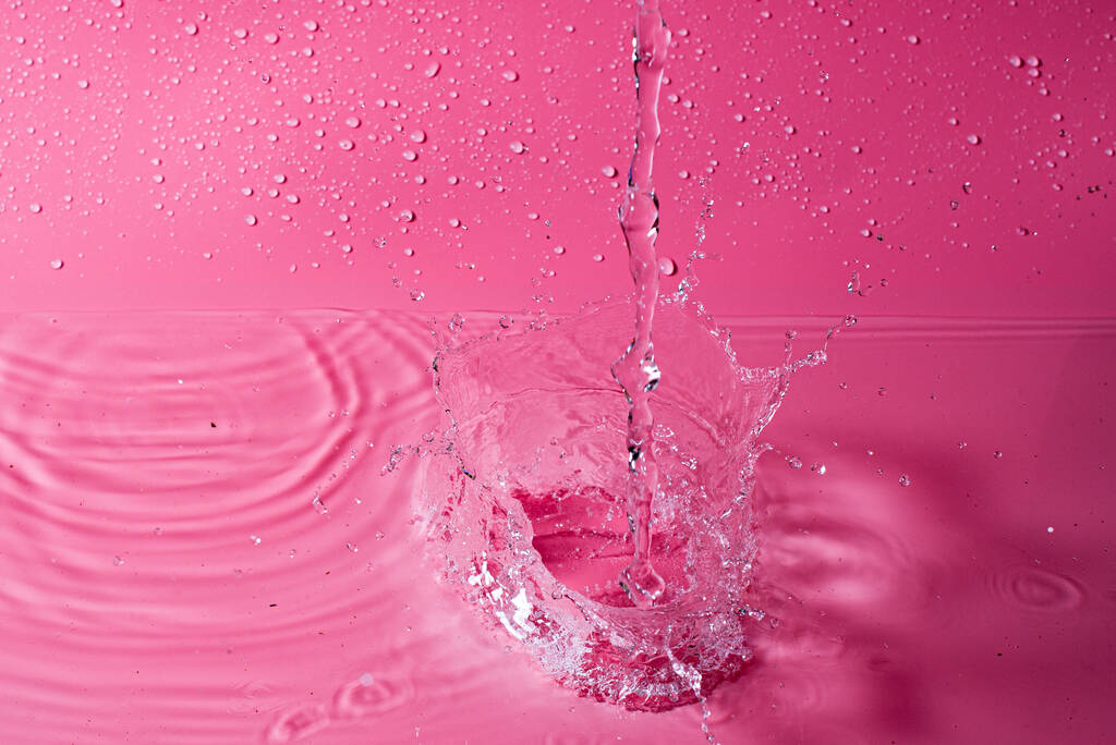 splash of water on a red background. Abstract wallpaper - Photo, Image