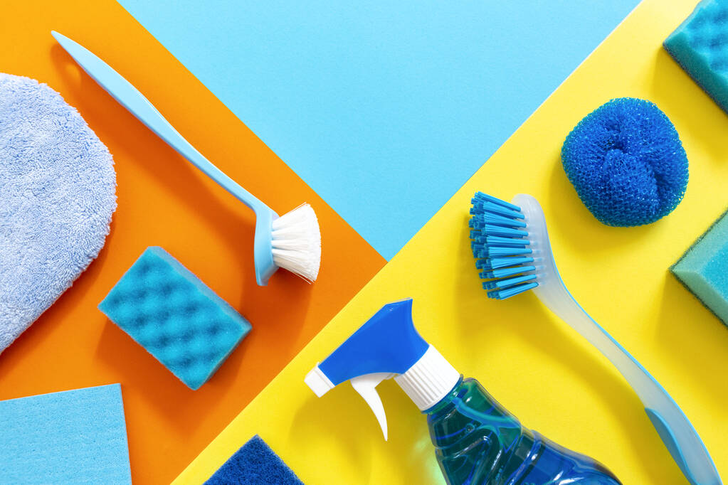 Blue set of cleaning tools on the colorfut backgrounds with geometric copy space. Clean up and spring-cleaning concept. - Photo, Image
