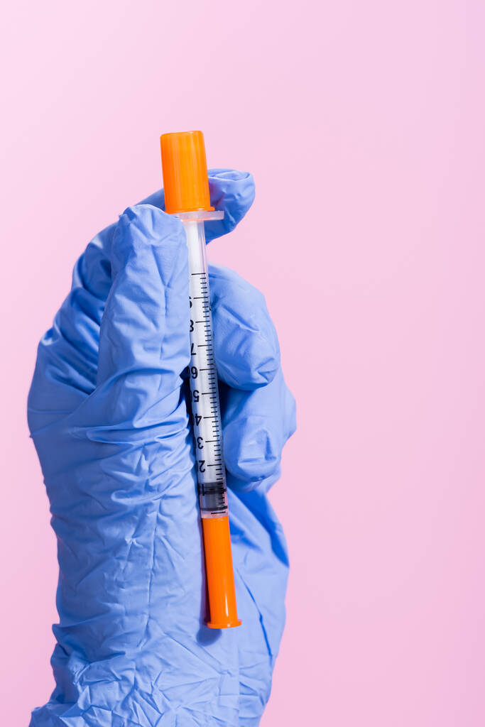 vista recortada de la mano en guante de látex con vacuna aislada en rosa - Foto, Imagen