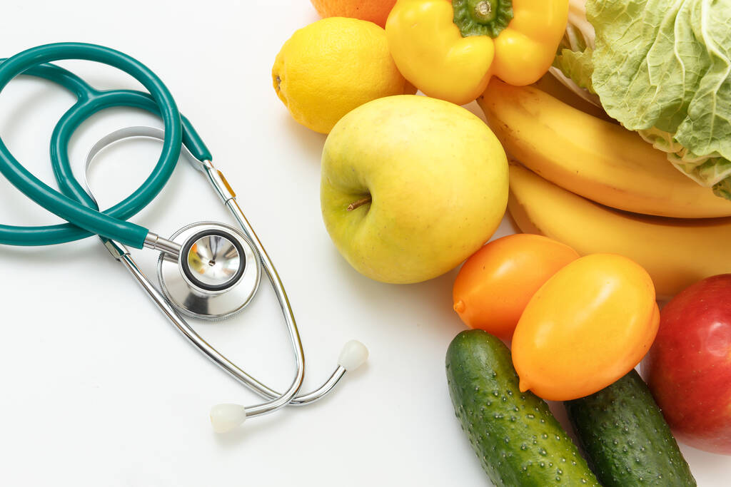 Nutrition and healthy eating. Fruits, vegetables, juice and stethoscope - Photo, Image