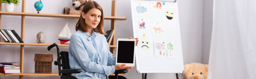 Žena psycholožka zobrazující digitální tablet s prázdnou obrazovkou při sezení na invalidním vozíku v kanceláři, banner - Fotografie, Obrázek