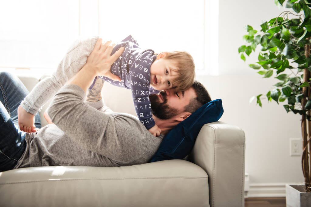 un padre e figlio giocare su il soggiorno insieme - Foto, immagini