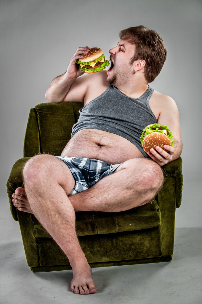 Kövér ember eszik hamburgert - Fotó, kép
