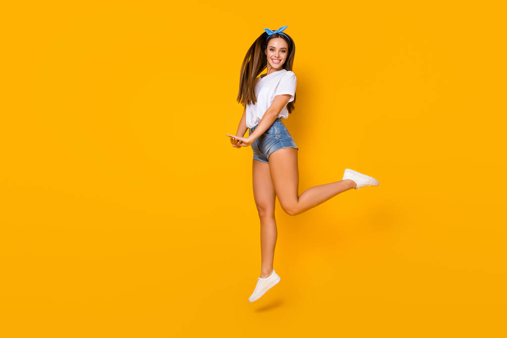Full body photo of cheerful excited energetic girl jump enjoy spring free time holiday weekend wear good look blue headband shoes isolated over bright color background - Photo, Image