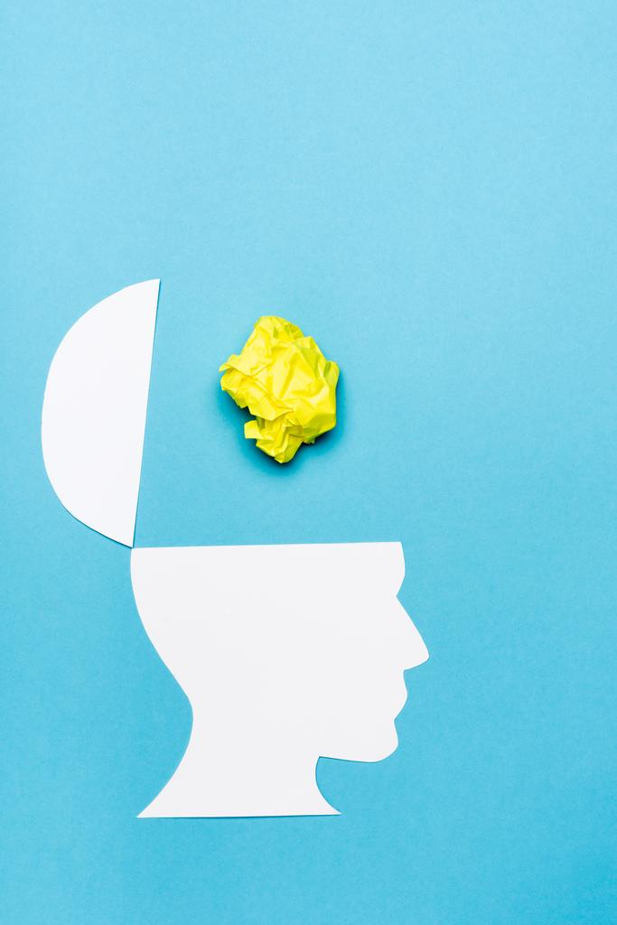 top view of paper human head and crumpled paper on blue background - Photo, Image