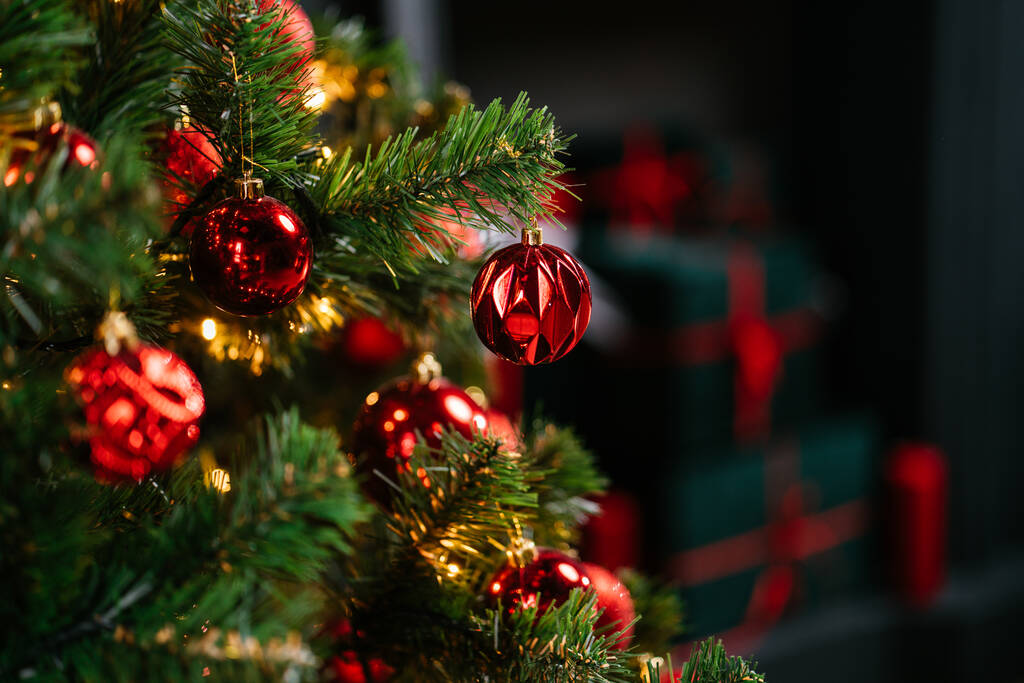 Ano Novo 2021 interior com velas, lâmpadas e bokeh. Quarto decorado para a celebração de Natal. árvore de Natal com presentes - Foto, Imagem