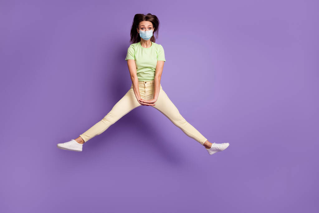 Full length view of girl jumping having fun fooling wear mask isolated bright vivid shine vibrant lilac violet color background - Photo, Image