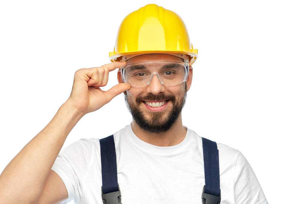 happy male worker or builder in helmet and overall - Photo, Image