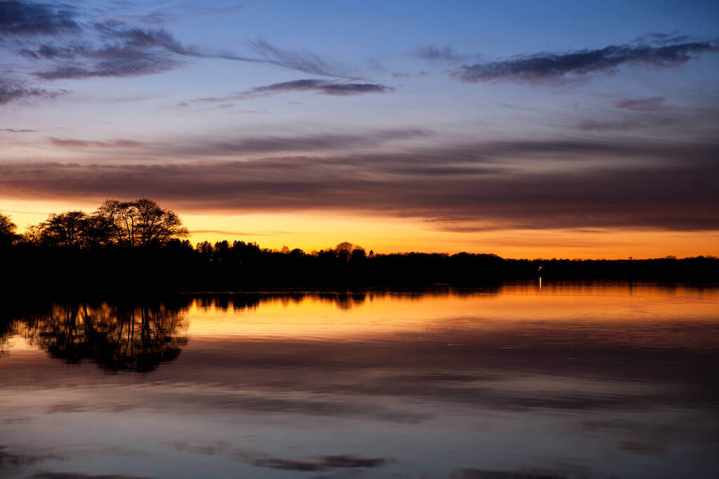 デンマークのRudersdalにあるSjaelsoe湖の日没 - 写真・画像