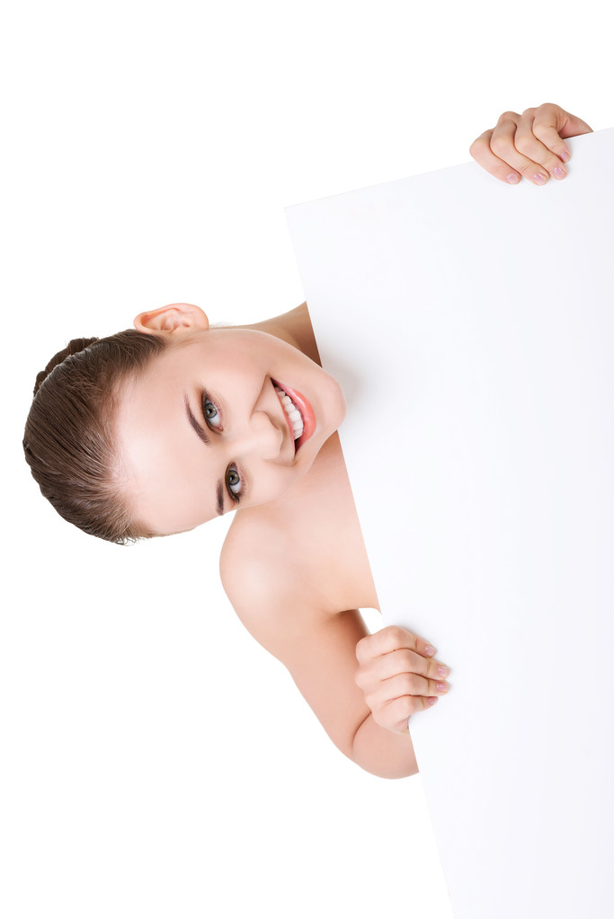 Mujer con piel perfecta sosteniendo tablero en blanco
 - Foto, imagen