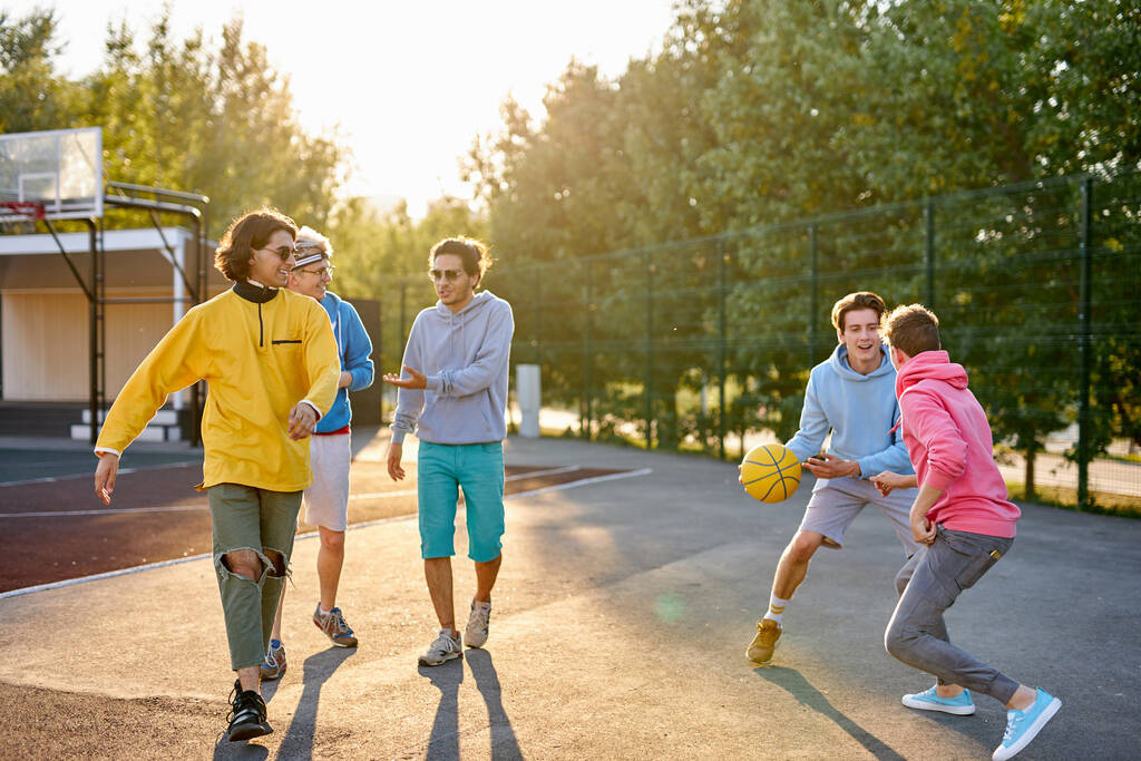 group of young male teenagers playing basketball outdoors - Photo, Image
